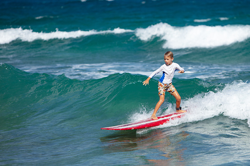 young boy learning to surf in St. John, virgin islands