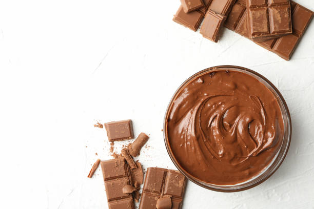 istock Bowl with chocolate and chocolate pieces on white background 1252871057