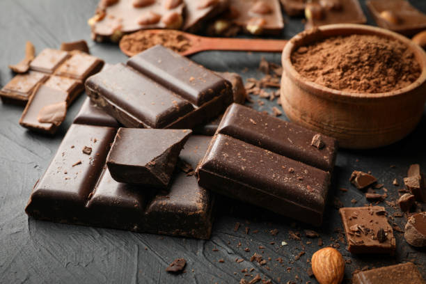 istock Chocolate, melted chocolate and almond on black background 1252872146