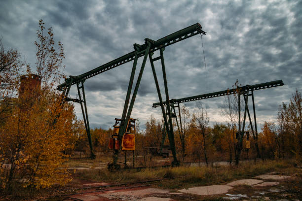 Old rusty gantry bridge crane in abandoned industrial area.