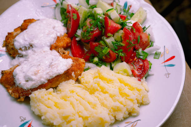 istock Mashed potatoes, chicken and salad on a plate 1252876161
