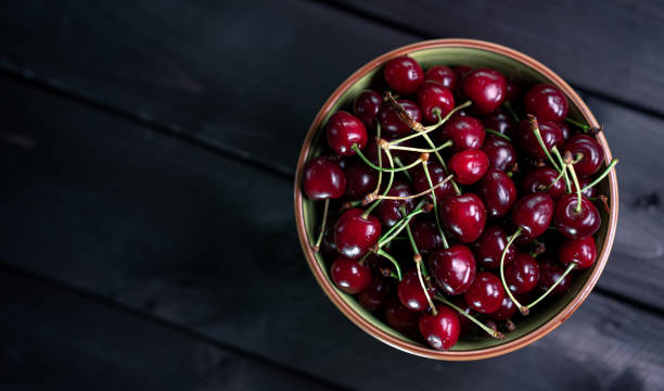 istock Cherry in a bowl on a wooden background 1252876188