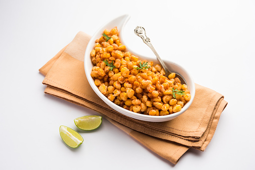 Crispy Fried Corn is a Chatpata starter snack from India, served in a bowl, selective focus