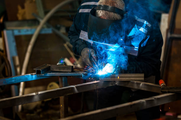 istock Construction worker welding a metal part of a garage door 1252878771