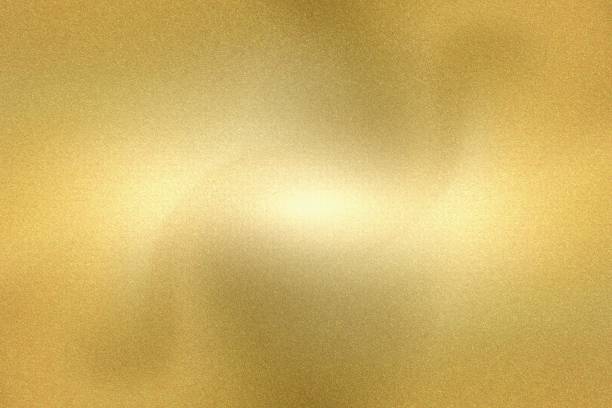 istock Light shining down on gold foil metallic wall, abstract texture background 1252879722