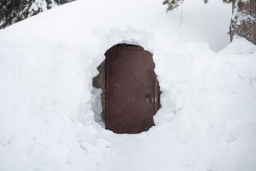 A closed door in a deep snow.