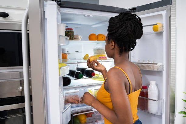 istock African American Woman Near Open Refrigerator 1252880907