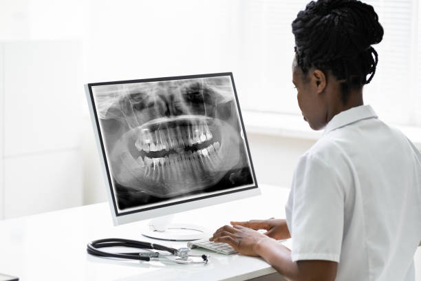 istock Dentist Doctor Looking At Teeth Xray 1252880975
