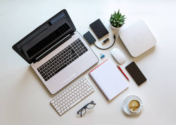istock Nice and bright work desk with computer equipment and coffee, overhead view 1252882957