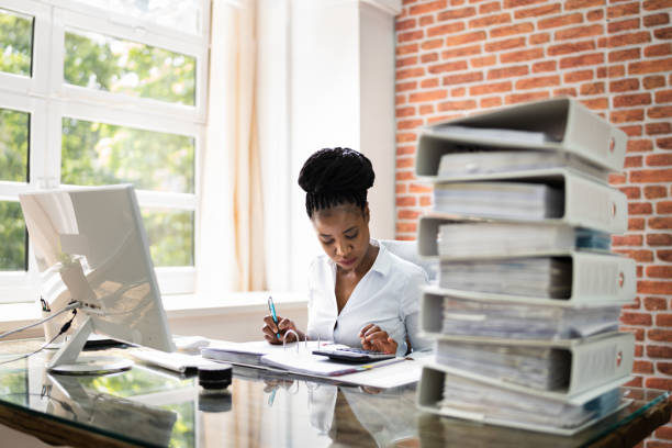 istock Young Businesswoman Working At Office With Stack Of Folders 1252883445