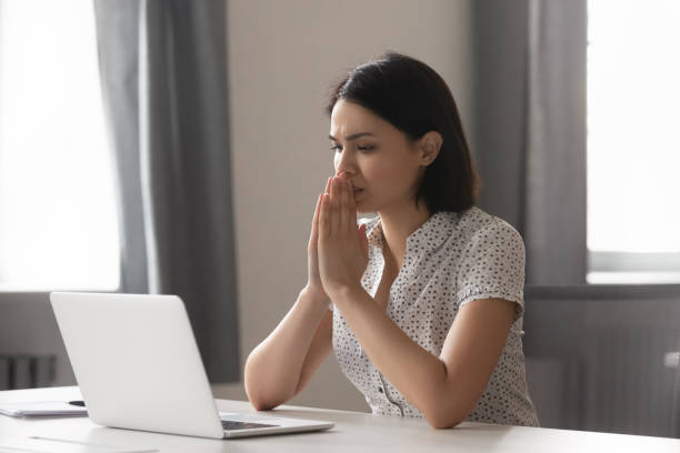 Stressed upset manager thinking about problem solution. Sad worried asian female employee looking at laptop screen at office. Stressed upset manager stuck with hard task, thinking about correct difficult decision or hard problem solution, hoping for help. melancholy computer support specialist stock pictures, royalty-free photos & images