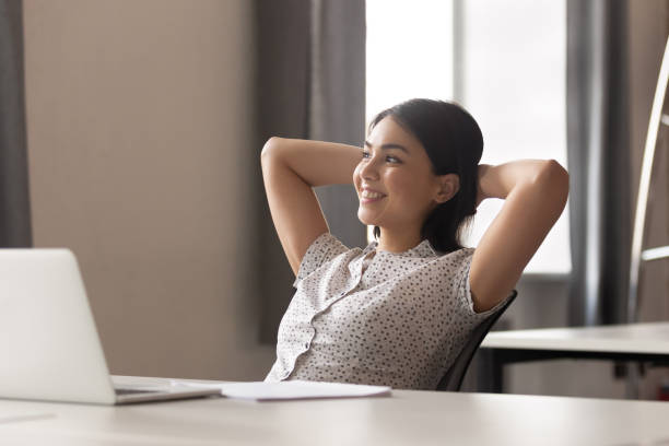 istock Happy peaceful asian female employee relaxing during working day break. 1252884565