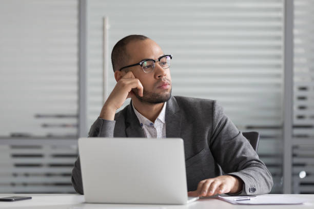 Thoughtful african american businessman thinking of problem solution.