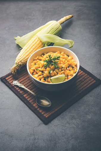 Spicy Masala Sweet Corn is a tasty roadside Indian snack, which is very easy to make. selective focus