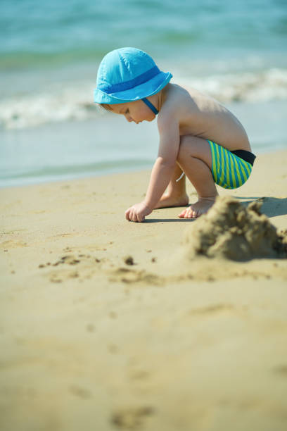 istock Little boy playing on the beach 1252890189
