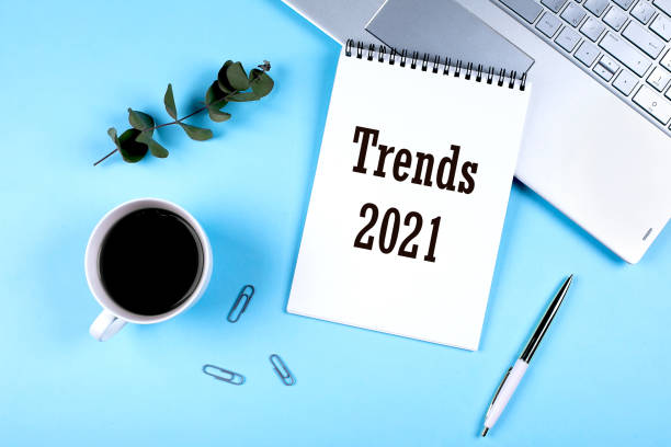 istock 2021 Trends concept. Flat lay office workspace with notebook, eucalyptus, cup of coffee. Top view. copy space 1252893082