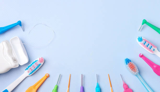istock Different toothbrushes and dental floss on blue, close up. 1252894103
