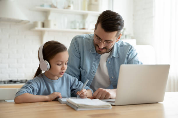 caring father help little daughter with school subject - child computer laptop little girls imagens e fotografias de stock
