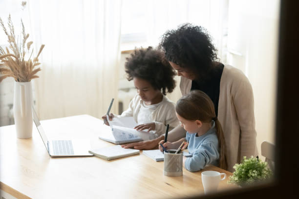 istock African mom helps to multiethnic siblings daughters with homework 1252896409