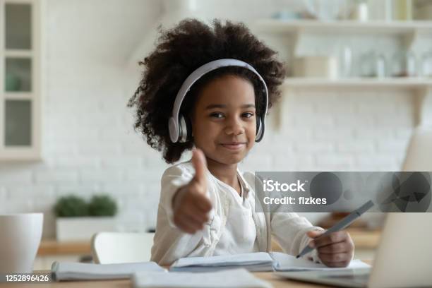 African Girl In Headphones Enjoy Showing Thumbs Up Elearning Stock Photo - Download Image Now