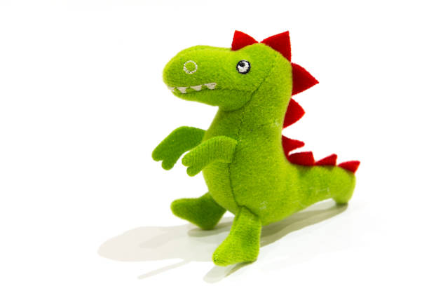 grüne plüsch dinosaurier puppe - drache kuscheltier stock-fotos und bilder