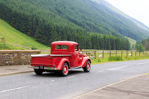 Moffat, Scotland - June 29, 2019: 1937 Ford V8 Deluxe pick up truck in a classic car rally en route towards the town of Moffat, Dumfries and Galloway