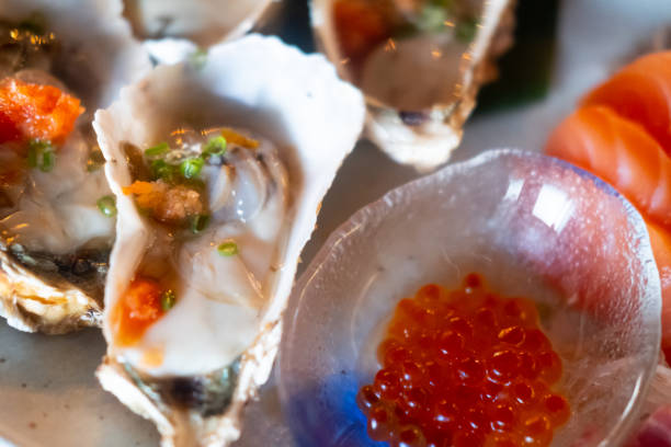 istock Raw fresh Japan oyster served with salmon roe. Close up 1252902072