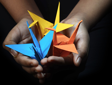 the paper crane is a design that is considered to be the most classic of all Japanese origami. In Japanese culture, it is believed that its wings carry souls up to paradise, and it is a representation of the Japanese red-crowned crane, referred to as the \
