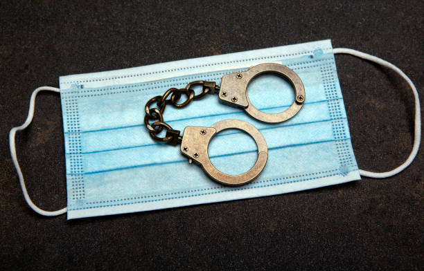 image of mask handcuff asphalt