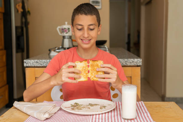 istock Boy about to eat melted cheese sandwich 1252906983