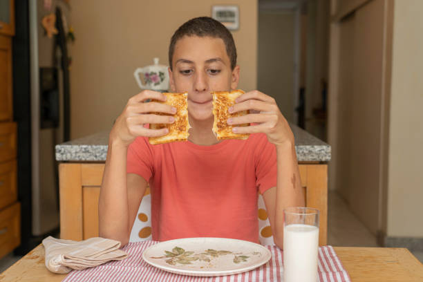 istock Boy about to eat melted cheese sandwich 1252906988