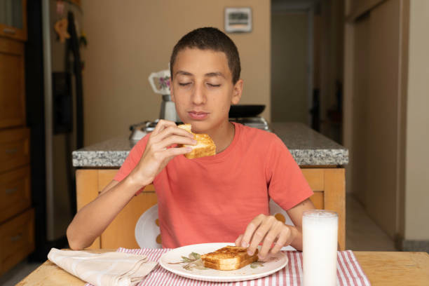 istock Boy about to eat a sandwich 1252907015
