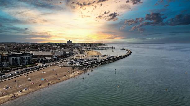 Sunset Over Neptunes Arm, Herne Bay, East Kent Aerial shot of Herne Bay. East Kent coastal town. the wall is a sea defence called Neptunes Arm, which curves round towards the remnants of the towns pier. herne bay photos stock pictures, royalty-free photos & images