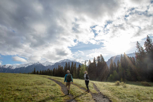 istock Mature couple hike along rural mountain trail 1252907399