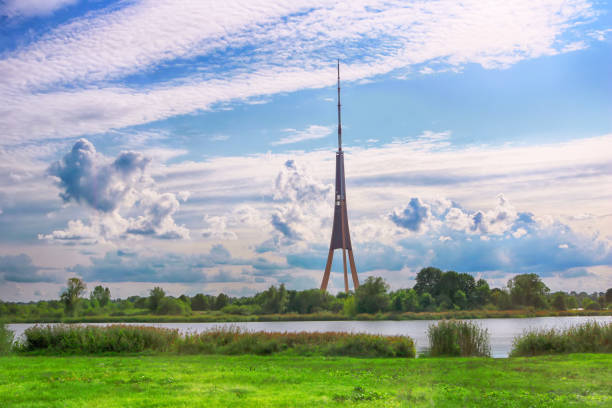 view of riga radio and tv tower and cloudy sky in riga, latvia. it is the tallest tower in the european union - daugava river imagens e fotografias de stock