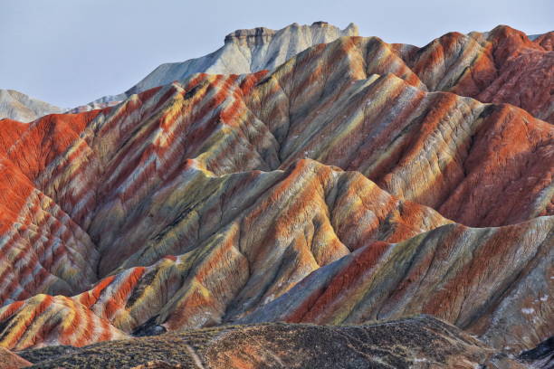 Small-Potala-Palace atop Seven-Color-Mountain landform from Colorful-Clouds-Observation-Deck. Zhangye Danxia-Qicai Scenic Spot-Gansu-China-0898 Spectacular colorful rusty sandstone and siltstone landforms of Zhangye Danxia-Red Cloud Nnal.Geological Park so called Rainbow Mountains-E.foothills of the Qilian Range. Zhangye-Gansu province-China. danxia landform stock pictures, royalty-free photos & images