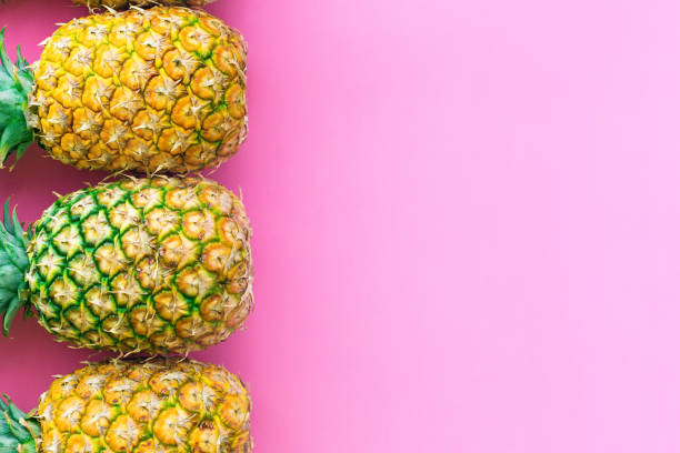 istock Pineapple tropical fruit on pink pastel background 1252910139