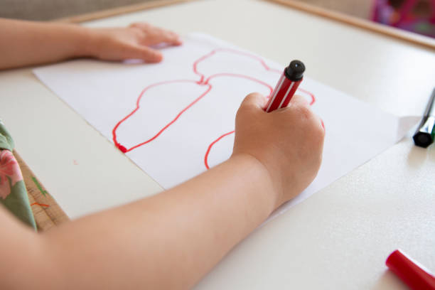 istock Little girl drawing on white paper 1252910476