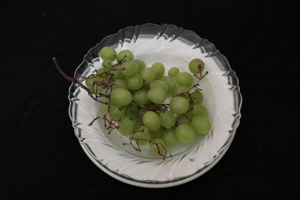 istock green grapes in white plate 1252912371