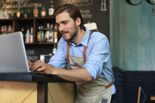 istock Restaurant manager working on laptop, counting profit. 1252913814
