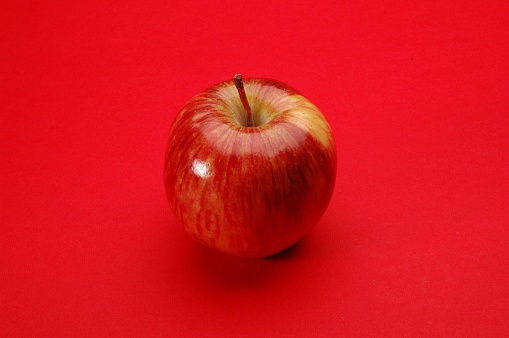 Red Apple on red background
