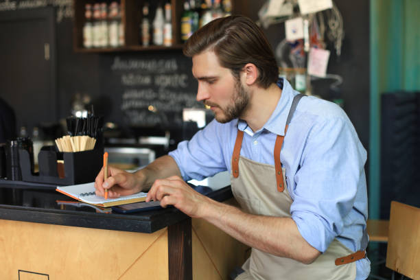 istock Small business owner working at his cafe. 1252915584