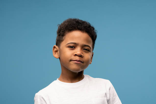 istock Adorable African child of elementary age squinting his eyes while looking at you 1252918995
