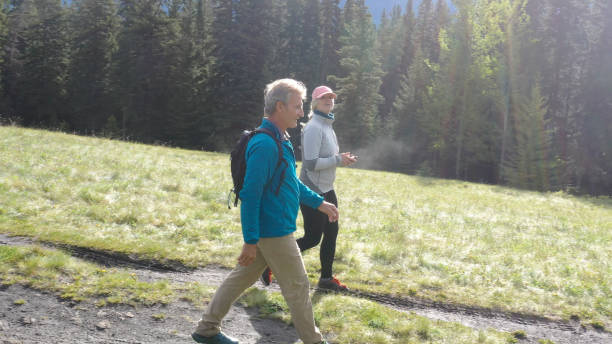 istock Mature couple hike along rural mountain trail 1252922710