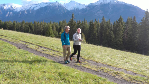 istock Mature couple hike along rural mountain trail 1252924129