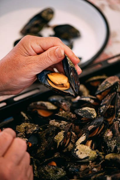 istock Woman Opening the Mussel’s Shells 1252924440