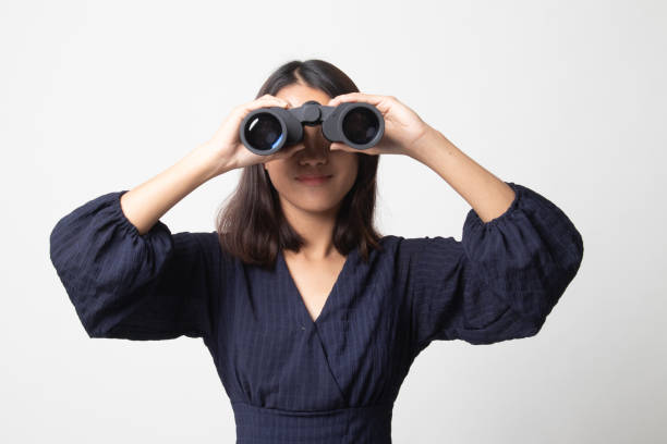 istock Young Asian woman with binoculars. 1252926317