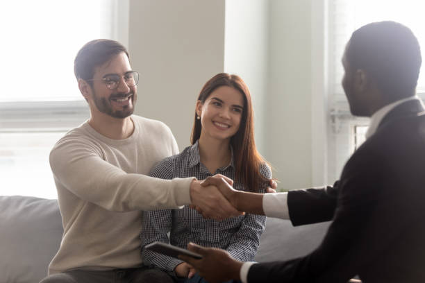 istock African estate agent and customers shake hands seated indoors 1252926475