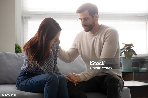 Guy Reassures Beloved Girl Holds Her Hand Showing Sincere Care Stock Photo - Download Image Now