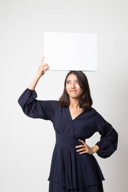 istock Young Asian woman with white blank sign. 1252926485